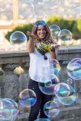 Blonde middle aged woman playing with bubble