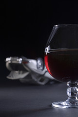Glass of alcohol on a blackground and an accident of simulated car