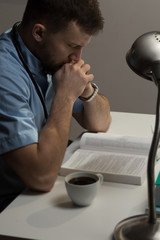 Hardworking surgeon sitting at desk