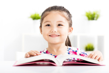 happy little girl Reading a Book