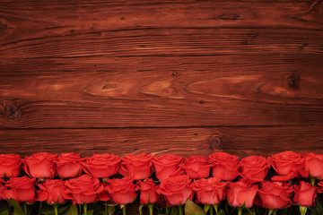 red roses with empty wooden copyspace above