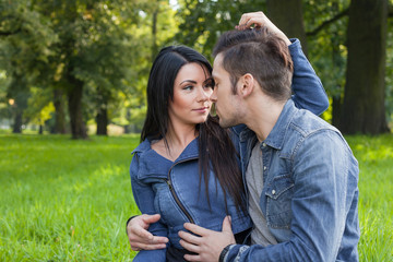 young couple in intimate moments in the park