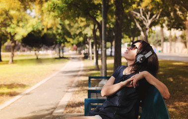 Beautiful Young Woman with Headphones Outdoors
