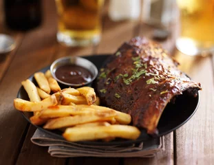 Fototapeten barbecue ribs with french fries and sauce on plate © Joshua Resnick