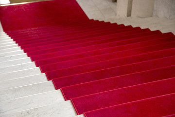 Red carpet on a stairway used to mark the route on ceremonial and formal occasions or events.