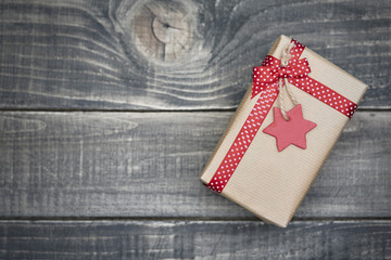 Fototapeta premium Christmas present wrapped in grey paper.