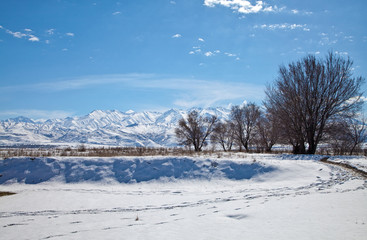 Panoramic landscape of snowy mountains in the spring