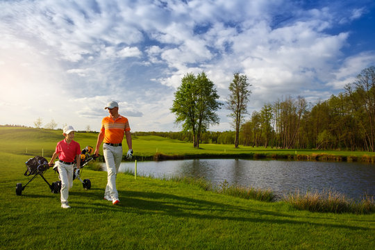 Father With Son At Golf Field