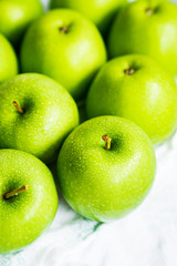 Bright green apples on white napkin