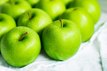Bright green apples on white napkin