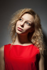Portrait of a beautiful blonde in a red dress.