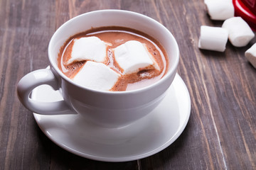 Hot cocoa with marshmallows the wooden table
