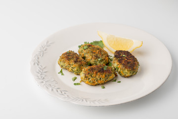 Rissoles with carrot and greens on the white background