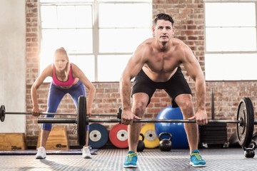 Two fit people working out