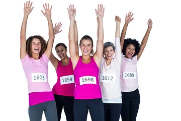 Portrait of happy female athletes with arms raised 