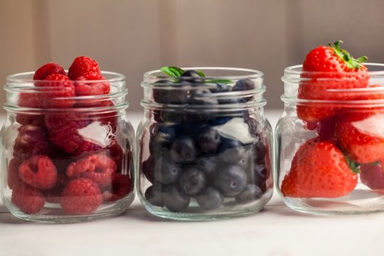 Glass jars of fresh berries