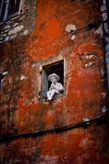 small stone man playing music with a flute