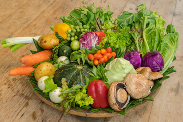 Close up of various colorful raw vegetables in the banana leaf basket.