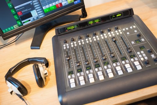 Sound mixer at desk in radio station