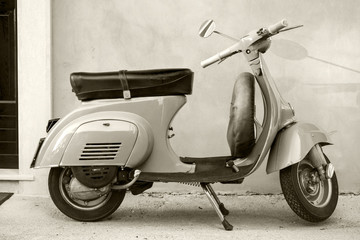 Classic Vespa scooter near the wall