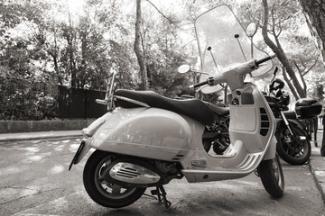 Fototapeta na wymiar Classic old style Vespa scooter stands parked