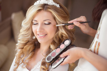 Beautiful smiling bride wedding portrait with makeup and hairsty