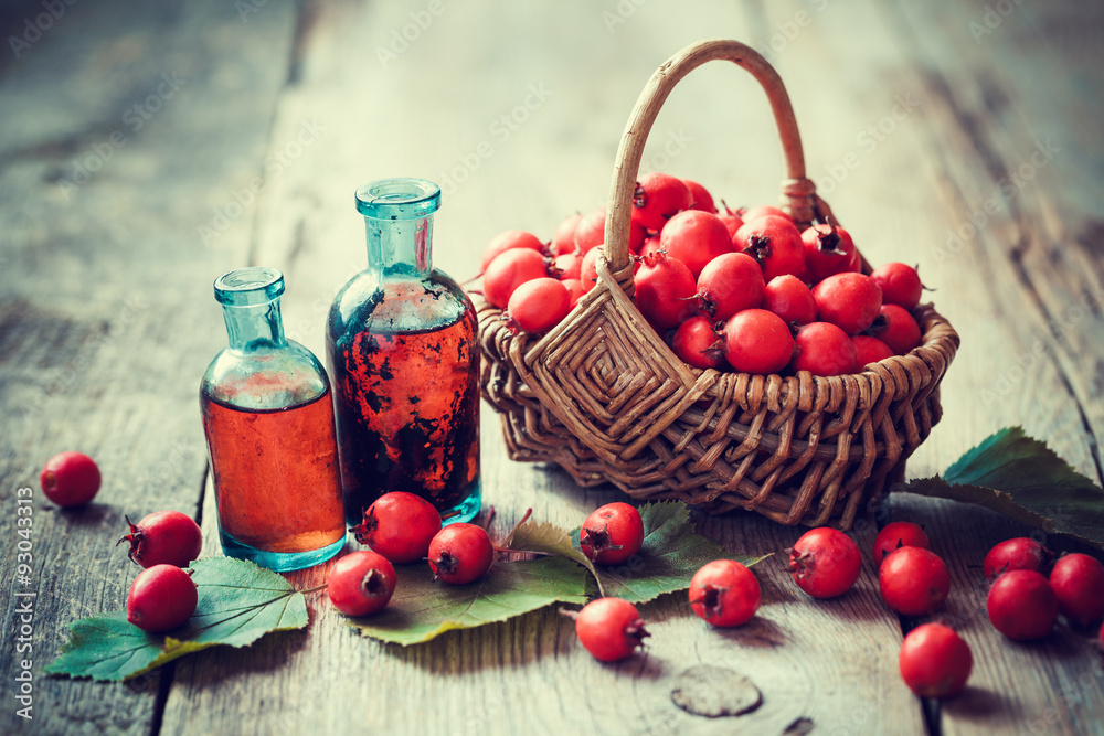 Sticker tincture bottles of hawthorn berries and ripe thorn apples in ba