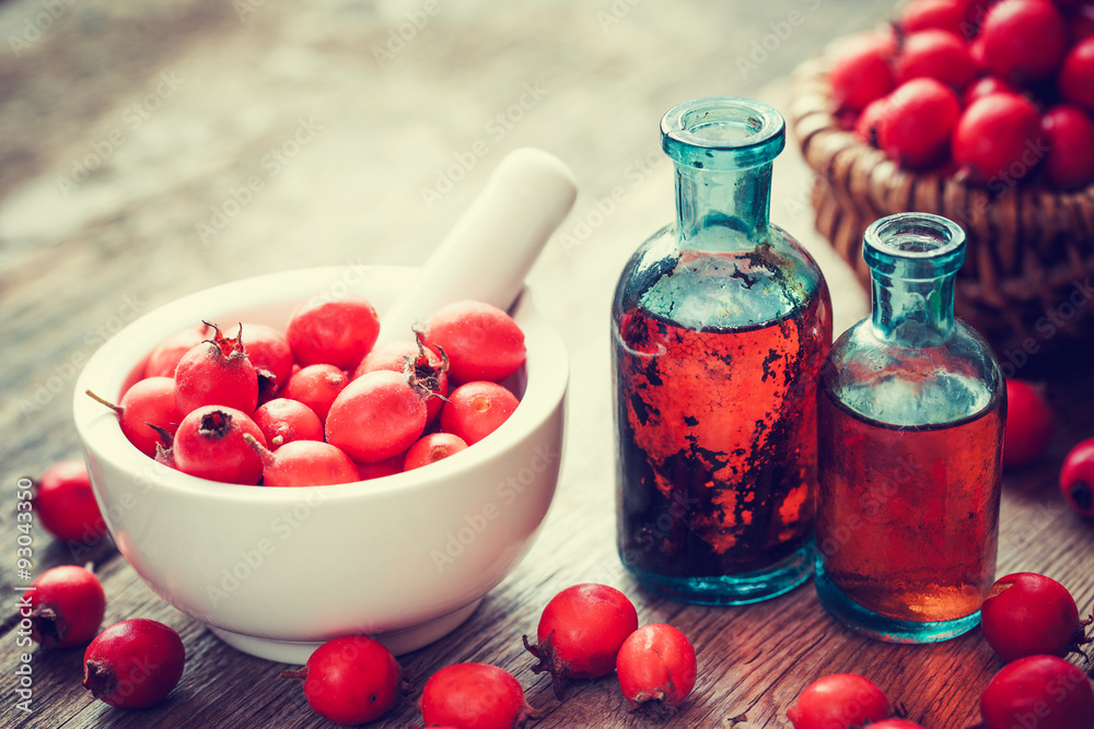 Wall mural mortar of hawthorn berries, two tincture bottles and thorn apple