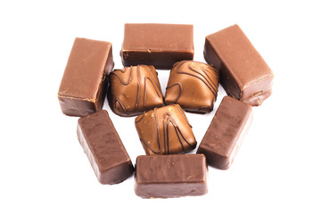 Assorted delicious chocolate candy isolated on white background, top view