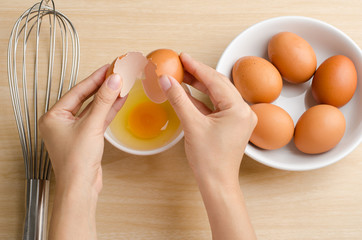 Cracking eggs without breaking yolk for cooking,food ingredient