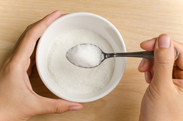 The spoon of sugar in the bowl,food ingredient for cooking sweet or dessert