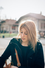Obraz premium Portrait of a young beautiful hipster sporty blonde woman in the