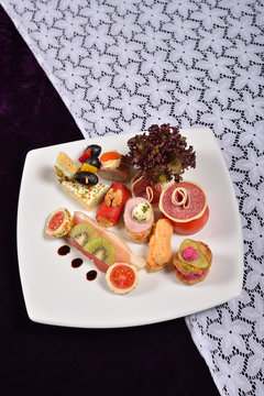 Antipasto and catering platter with different appetizers (fruits