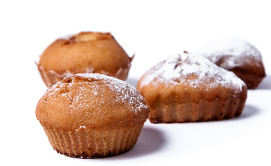 Delicious baked muffins on a white background