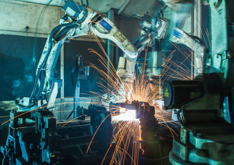Team Robot welding  movement Industrial automotive part in factory
