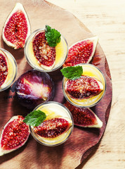 Creamy white yogurt with honey, figs and mint, top view, selecti