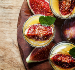 Creamy white yogurt with honey, figs and mint, top view, selecti