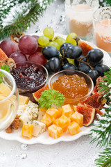 Fototapeta na wymiar delicacy cheese and fruit plate closeup vertical