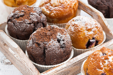 delicious muffins on a wooden tray