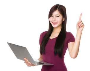 Asian young woman use of laptop computer and finger point up