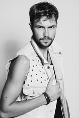 Black and white portrait of a stylish young man in the studio, lifestyle