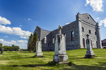 The Ruins of St. Raphael and its cemetery on a summer day.