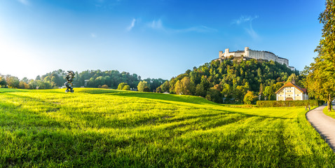 Idyllic summer fields with Fortress Hohensalzburg at sunset, Salzburger, Austria