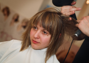 Naklejka premium Young woman at the hair studio