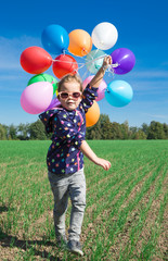Little girl playing with balloons