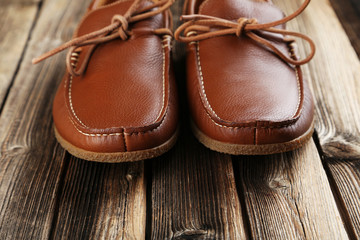 Fashion brown shoes on a brown wooden table