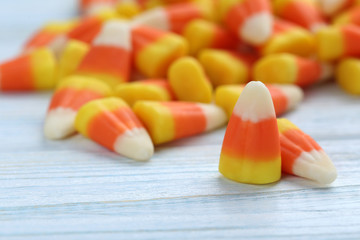 Halloween candy corns on blue wooden background
