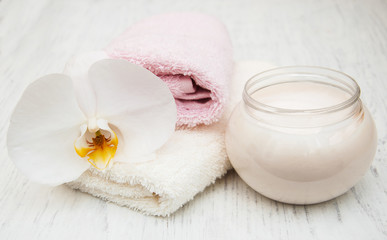 spa essentials cream white towels and orchids