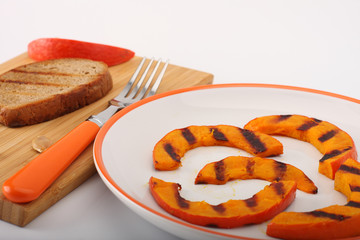 Grilled pumpkin hokkaido with toasted bread on white