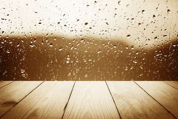 Abstract rain drops on a window or water drops on grass and wood